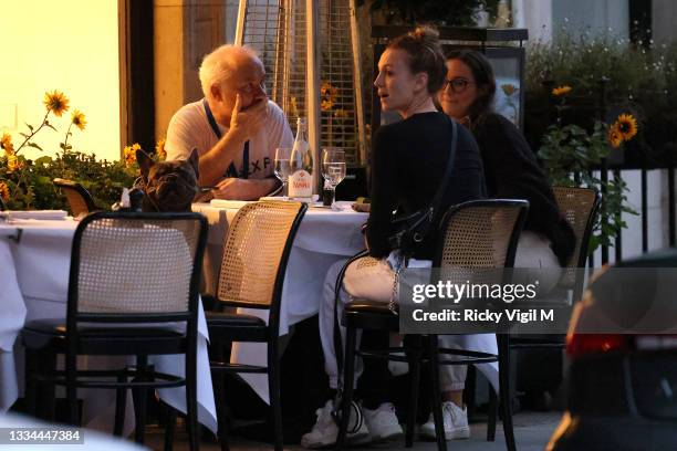 Damien Hirst and Sophie Cannell enjoy dinner at Scott's restaurant in Mayfair with their dogs on August 13, 2021 in London, England.