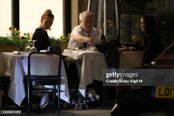 Damien Hirst and Sophie Cannell enjoy dinner at Scott's restaurant in Mayfair with their dogs on August 13, 2021 in London, England.