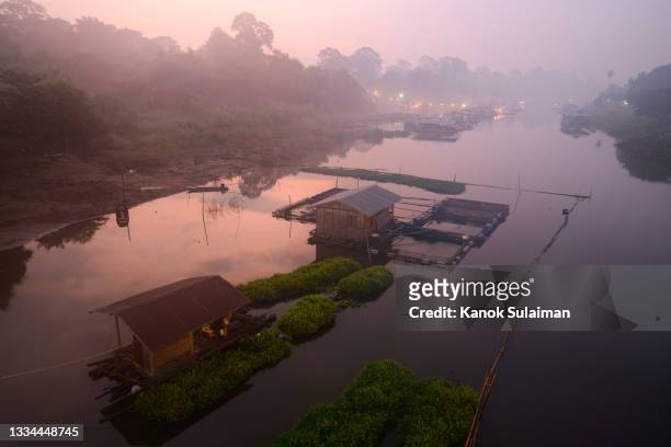 fog rolling through rural landscape with houseboat in river - asia village river bildbanksfoton och bilder