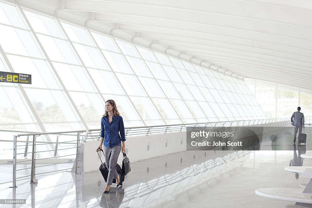 Woman with luggage walking at airport