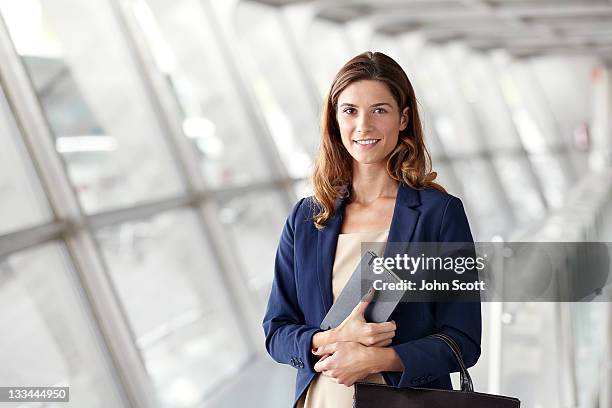 woman smiling to camera with bag and notebook - notebook smiling business foto e immagini stock