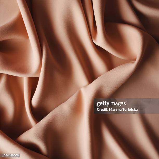 brown fabric wavy background. - chocolate square stock pictures, royalty-free photos & images