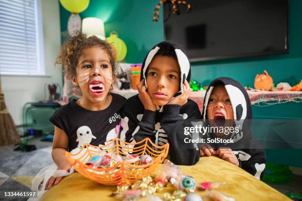 spooky siblings! - halloween candy stock pictures, royalty-free photos & images