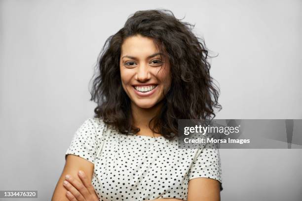 beautiful hispanic woman against white background - smiling stock-fotos und bilder