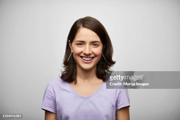 happy hispanic woman against gray background - purple lilac stock pictures, royalty-free photos & images