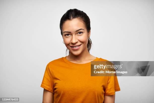 happy hispanic woman against white background - frau stock-fotos und bilder