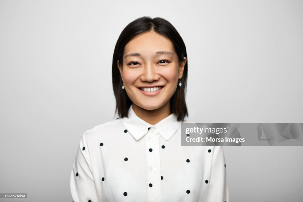 Confident Chinese Businesswoman Against White Background