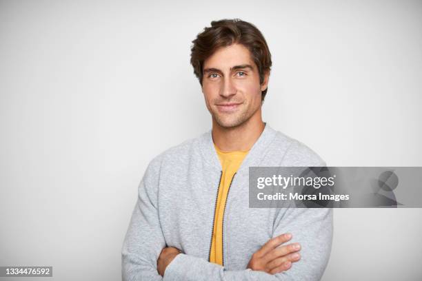 confident man in casuals against white background - male model stock pictures, royalty-free photos & images