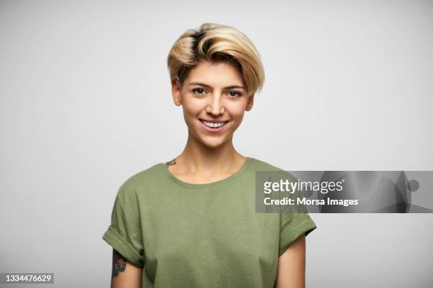 happy hispanic female with blond short hair - short fotografías e imágenes de stock