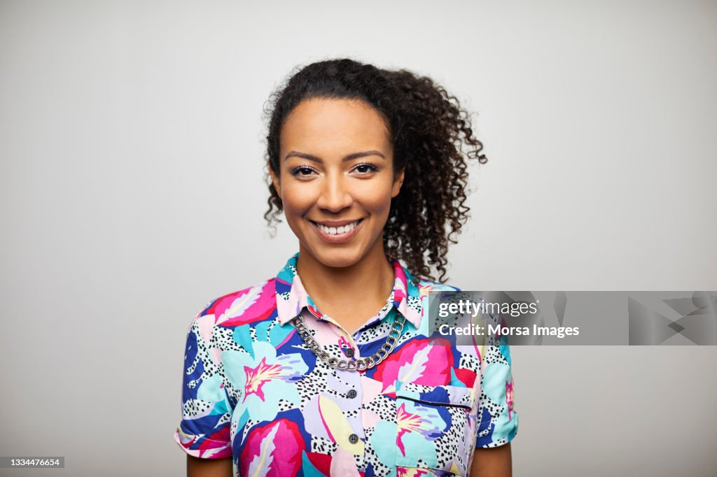 Smiling African American Woman Against Gray Background