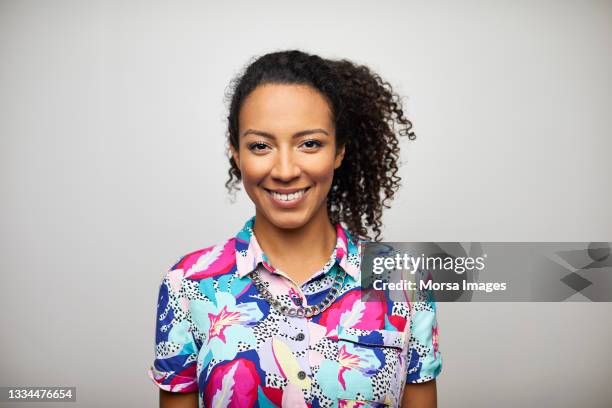 smiling african american woman against gray background - floral pattern shirt stock pictures, royalty-free photos & images