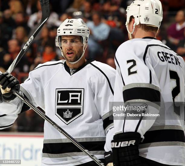 Simon Gagne of the Los Angeles Kings and Matt Greene of the Los Angeles Kings skate on the ice during a break in action against the Anaheim Ducks...