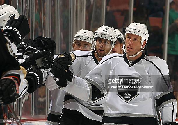 Rob Scuderi of the Los Angeles Kings high fives teammates celebrating a second period goal from teammate Simon Gagne of the Los Angeles Kings against...