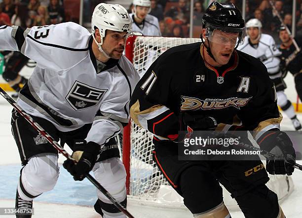 Saku Koivu of the Anaheim Ducks battles against Willie Mitchell of the Los Angeles Kings during the game on November 17, 2011 at Honda Center in...