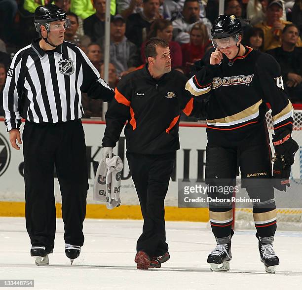 Cam Fowler of the Anaheim Ducks is helped off the ice during the game against the Los Angeles Kings on November 17, 2011 at Honda Center in Anaheim,...