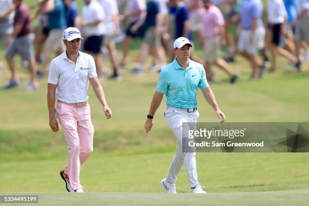 Justin Thomas and Rory McIlroy of Ireland walk down the first hole during the final round of the World Golf Championship-FedEx St Jude Invitational...