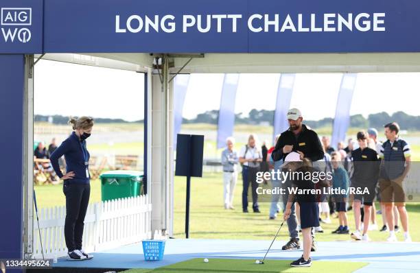 Golden Ticket Winner takes part in the long putt challenge in the spectator village during a practice day prior to the AIG Women's Open at Carnoustie...