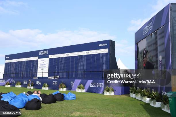Golden Ticket Winners watch the big screen in the spectator village during a practice day prior to the AIG Women's Open at Carnoustie Golf Links on...