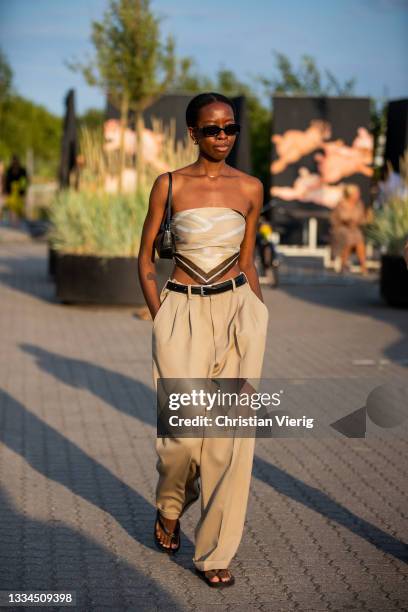 Guest is seen wearing beige pants, cropped top outside Rotate on August 12, 2021 in Copenhagen, Denmark.