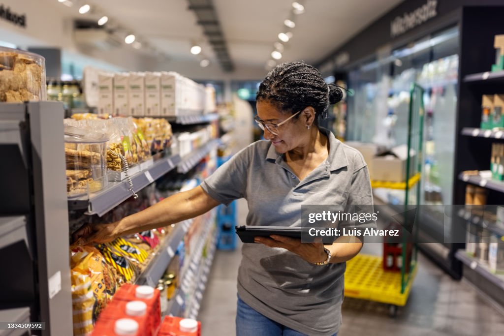 Supermarket employee working in the store