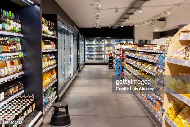 interior of a supermarket with products displayed on the racks - supermarket bildbanksfoton och bilder