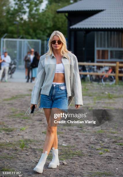 Guest is seen wearing shorts, grey jacket, white boots outside Henrik Vibskov on August 12, 2021 in Copenhagen, Denmark.