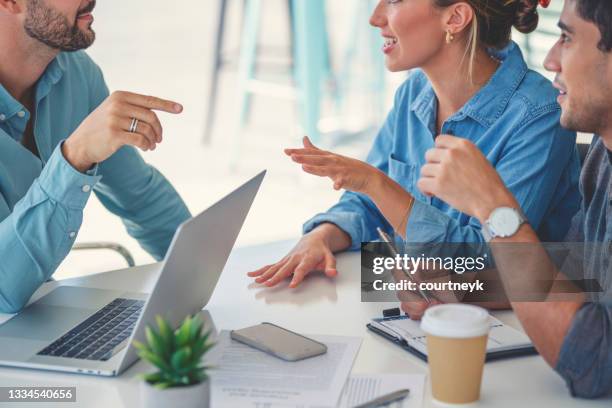financial advisor with couple looking through documents. - real estate closing stock pictures, royalty-free photos & images