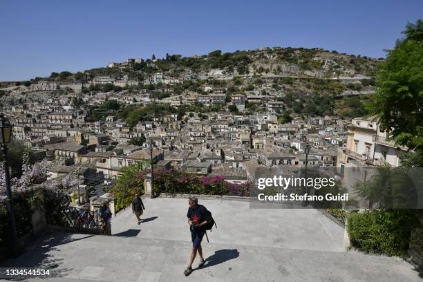 Tourists visit the Modica City on August 16, 2021 in Modica, Italy. Modica is a Sicilian city of Neolithic origins. Its historic center, rebuilt...