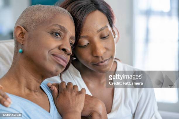 daughter embraces her mother after chemo - cancer illness stock pictures, royalty-free photos & images