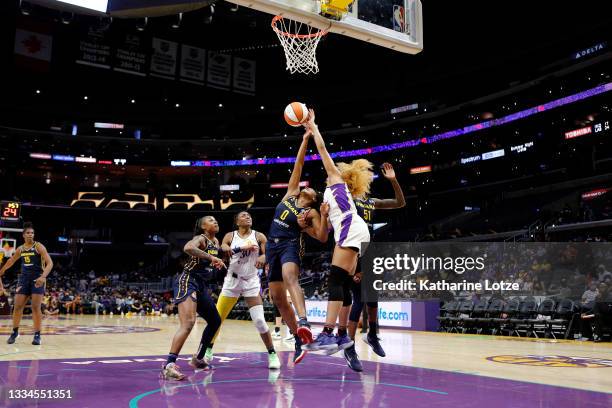 Kelsey Mitchell of the Indiana Fever and Arella Guirantes of the Los Angeles Sparks jump for a rebound during a game at Staples Center on August 15,...