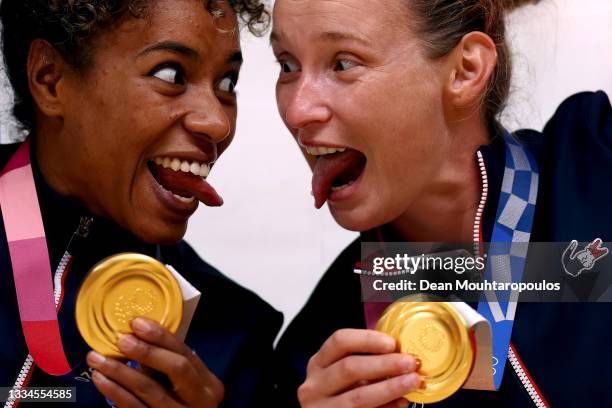 Estelle Nze Minko and Amandine Leynaud of Team France celebrate with their gold medals during the medal ceremony for Women's Handball on day sixteen...