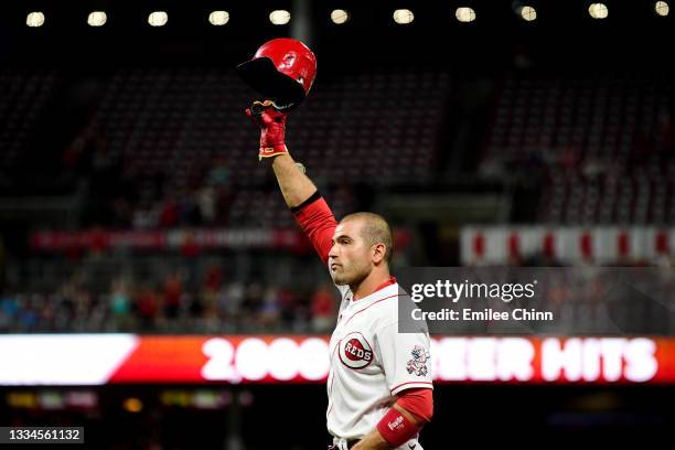 Joey Votto of the Cincinnati Reds gives a curtain call after hitting a single for his 2,000th career hit in the seventh inning against the Chicago...