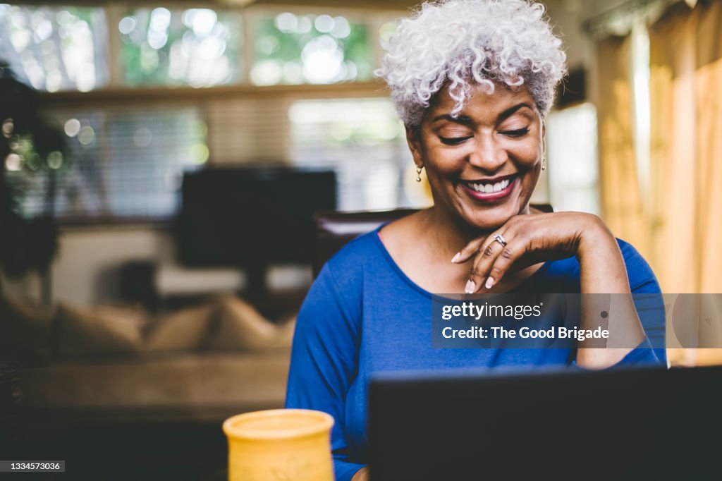 Cheerful woman on video call at home