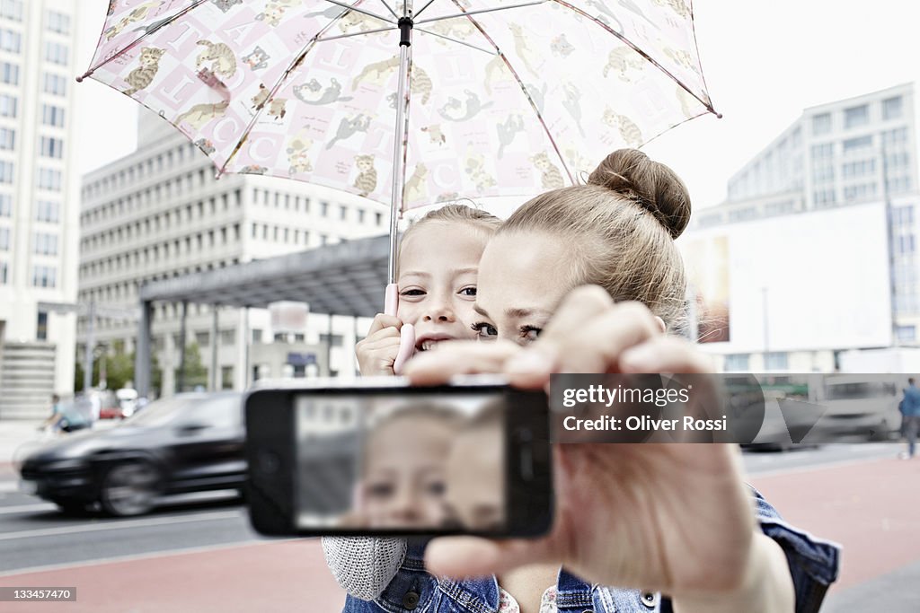 A mother and her daughter taking photos