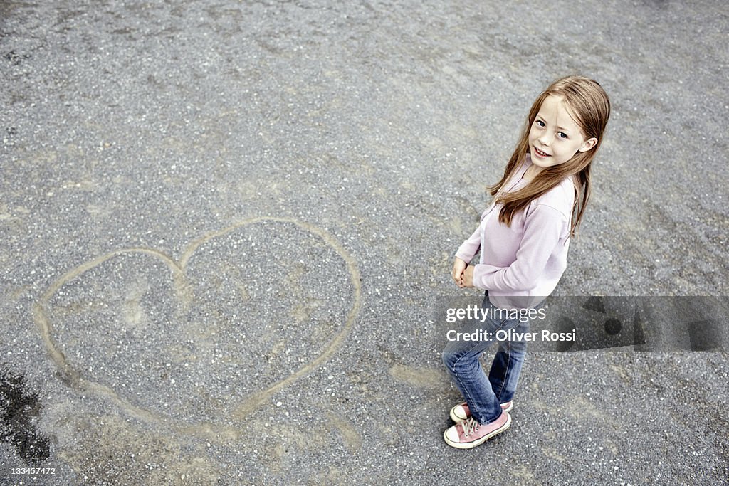 Portrait of a young girl and a drawn heart