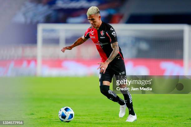 Luis Ricardo Reyes of Atlas drives the ball during the 3rd round match between Pachuca and Atlas as part of the Torneo Grita Mexico A21 Liga MX at...