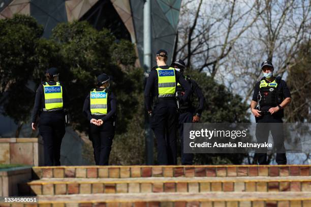 Police are seen on patrol at Federation Square on August 17, 2021 in Melbourne, Australia. Lockdown restrictions have been extended for another two...