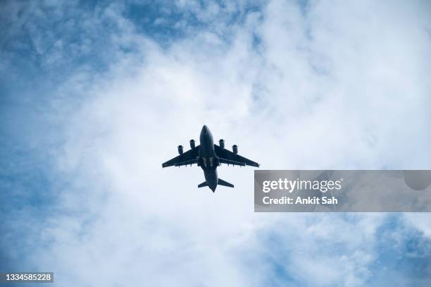 indian air force boeing c-17 globemaster iii military transport aircraft flying in the sky. - indian air force stock pictures, royalty-free photos & images