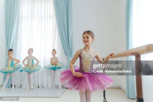 little ballerina practicing next to a barre - ballet girl stock pictures, royalty-free photos & images