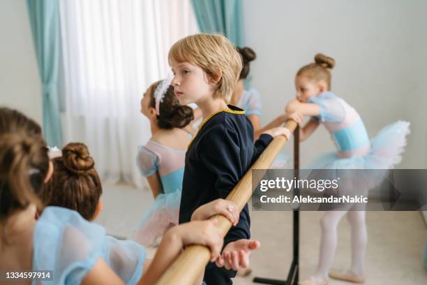 male ballet dancer practicing posture by a barre - ballet boy stockfoto's en -beelden