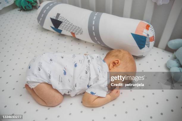 baby sleeping on his stomach at crib - lying on front stock pictures, royalty-free photos & images