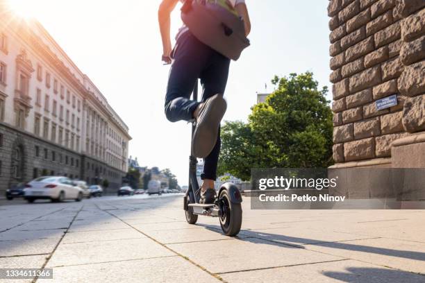 homme conduisant une trottinette électrique le matin - mobility scooter photos et images de collection