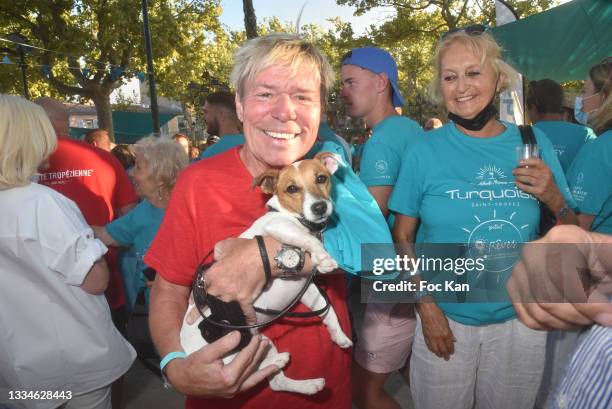 Chef Yvan and dog Nina attend Petanque Turquoise Auction Contest at Place des lices on August 16, 2021 in Saint Tropez, France.