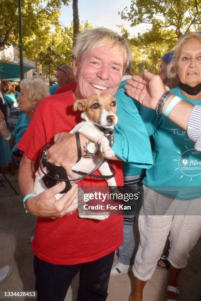 Chef Yvan and dog Nina attend Petanque Turquoise Auction Contest at Place des lices on August 16, 2021 in Saint Tropez, France.