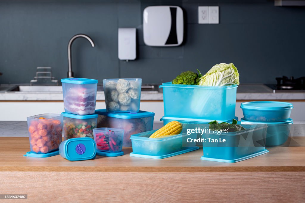 Plastic containers with fresh foods and vegetables