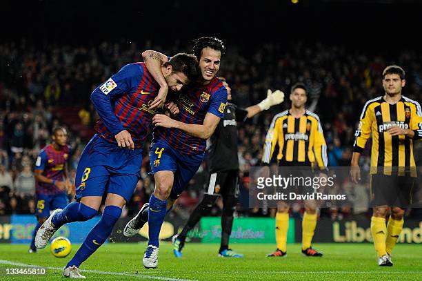 Gerard Pique of FC Barcelona celebrates with his teammate Cesc Fabregas of FC Barcelona after scoring the opening goal during the la Liga Match...