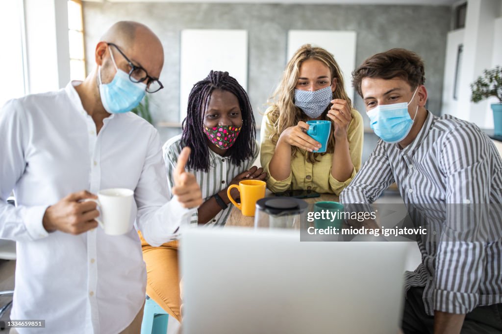Videoconference Mask Colleagues With Protective Face Masks Having A Video Conference From ...