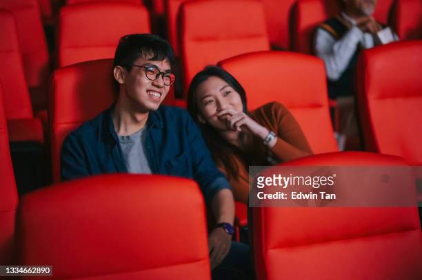 asian chinese young couple enjoy watching movie show in cinema bonding time - asian cinema bildbanksfoton och bilder