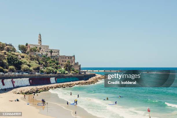 mediterranean beach with distant view of old jaffa - jaffa stockfoto's en -beelden