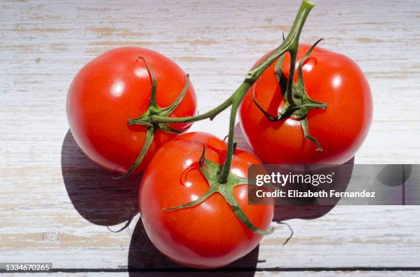 vine tomatoes on wooden  background, top view - tomatoes ストックフォトと画像